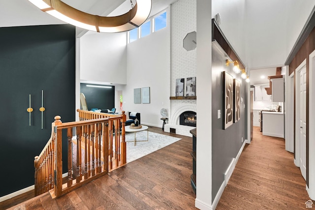 3348 E Stonehill Ln, Cottonwood Heights, UT 84121 - corridor with an upstairs landing, a high ceiling, wood-type flooring, and baseboards
