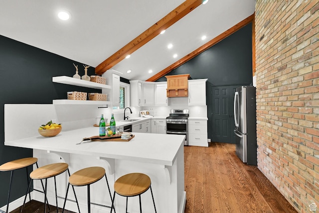 3348 E Stonehill Ln, Cottonwood Heights, UT 84121 - kitchen with stainless steel appliances, a sink, a peninsula, light wood-type flooring, and beamed ceiling