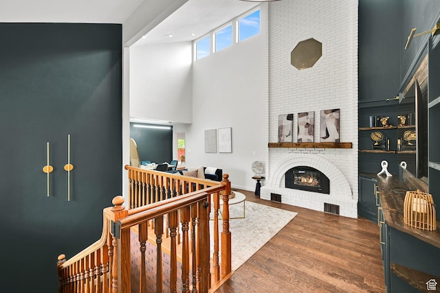 3348 E Stonehill Ln, Cottonwood Heights, UT 84121 - living area with a high ceiling, a brick fireplace, and wood finished floors