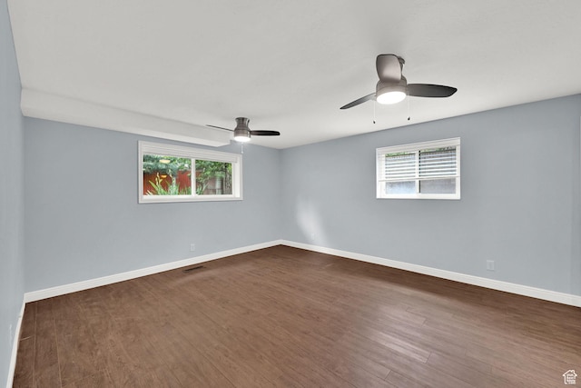 3348 E Stonehill Ln, Cottonwood Heights, UT 84121 - unfurnished room with healthy amount of natural light, dark wood-style floors, and baseboards