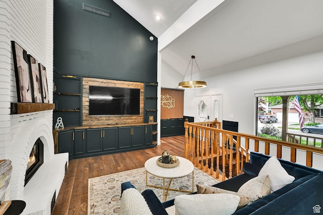 3348 E Stonehill Ln, Cottonwood Heights, UT 84121 - living area featuring a brick fireplace, wood finished floors, high vaulted ceiling, and recessed lighting