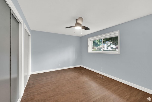 3348 E Stonehill Ln, Cottonwood Heights, UT 84121 - unfurnished bedroom with a closet, baseboards, dark wood-style flooring, and a ceiling fan