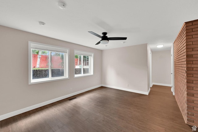 3348 E Stonehill Ln, Cottonwood Heights, UT 84121 - spare room with dark wood finished floors, a ceiling fan, baseboards, brick wall, and a smoke detector
