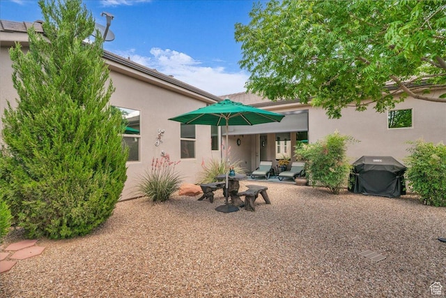 1865 N Park Grove Dr, Washington, UT 84780 - back of property with a patio area and stucco siding