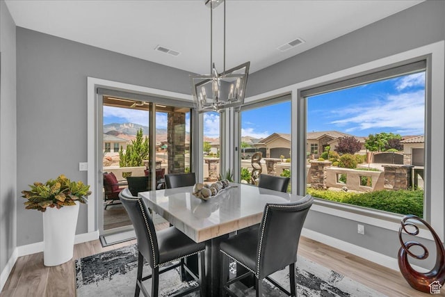 1865 N Park Grove Dr, Washington, UT 84780 - dining area with a chandelier, baseboards, and light wood-style floors