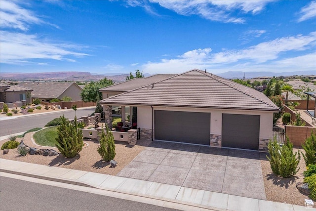 1865 N Park Grove Dr, Washington, UT 84780 - ranch-style house featuring stone siding, a mountain view, concrete driveway, and stucco siding