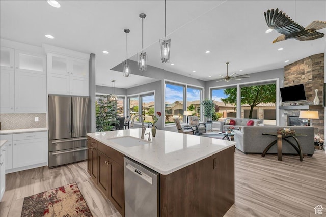 1865 N Park Grove Dr, Washington, UT 84780 - kitchen with stainless steel appliances, a sink, recessed lighting, white cabinetry, and decorative backsplash