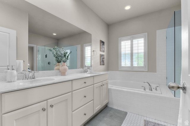 bathroom featuring a shower stall, a bath, double vanity, tile patterned flooring, and recessed lighting