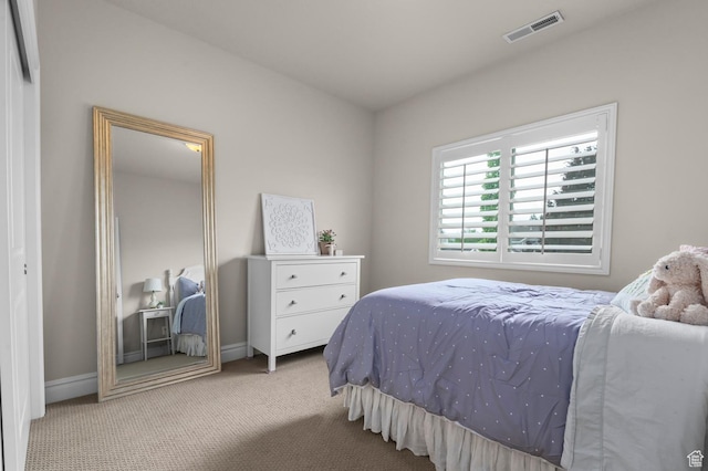 carpeted bedroom with baseboards