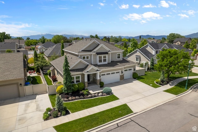 view of front facade with a residential view, driveway, a gate, and a mountain view