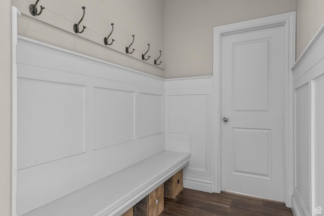 mudroom featuring a decorative wall, a wainscoted wall, and dark wood finished floors