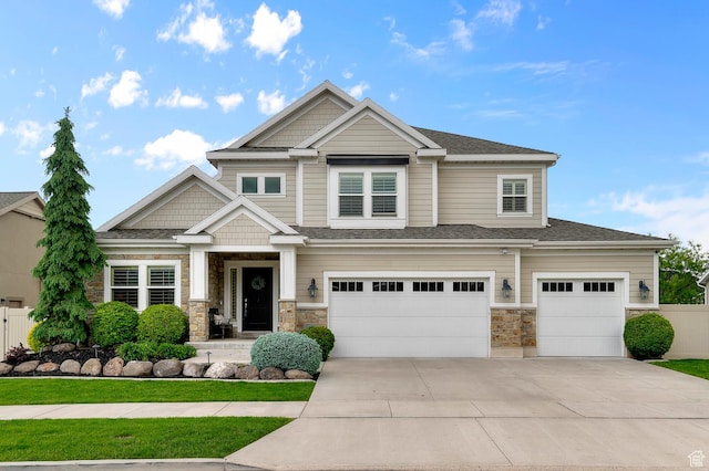 craftsman house with concrete driveway, stone siding, a garage, and fence