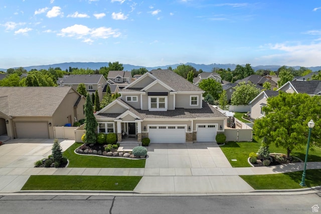 view of front facade featuring concrete driveway, a gate, a residential view, and an attached garage