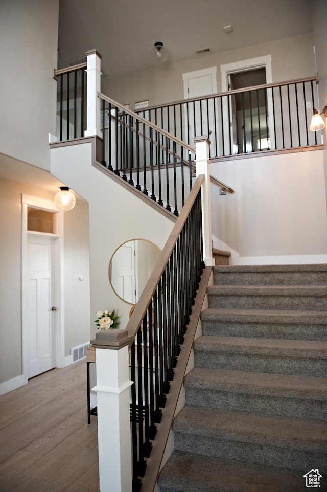 224 S Dry Creek Ln W, Vineyard, UT 84058 - stairway with wood finished floors, baseboards, and a towering ceiling