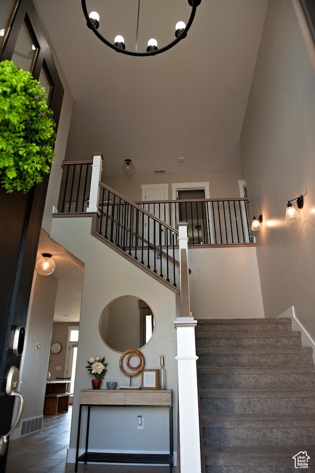 224 S Dry Creek Ln W, Vineyard, UT 84058 - stairway featuring a towering ceiling, baseboards, wood finished floors, and a chandelier