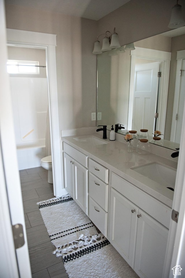 224 S Dry Creek Ln W, Vineyard, UT 84058 - bathroom featuring toilet, double vanity, and shower / bathtub combination