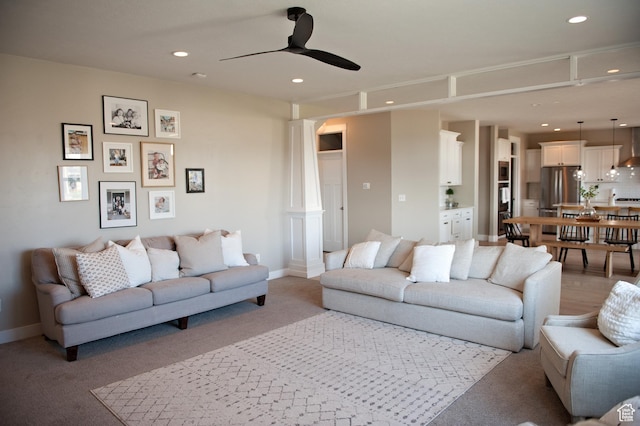 224 S Dry Creek Ln W, Vineyard, UT 84058 - living area with ornate columns, light colored carpet, a ceiling fan, recessed lighting, and baseboards