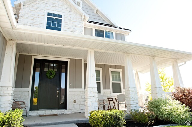 224 S Dry Creek Ln W, Vineyard, UT 84058 - view of exterior entry with stone siding, board and batten siding, and a porch