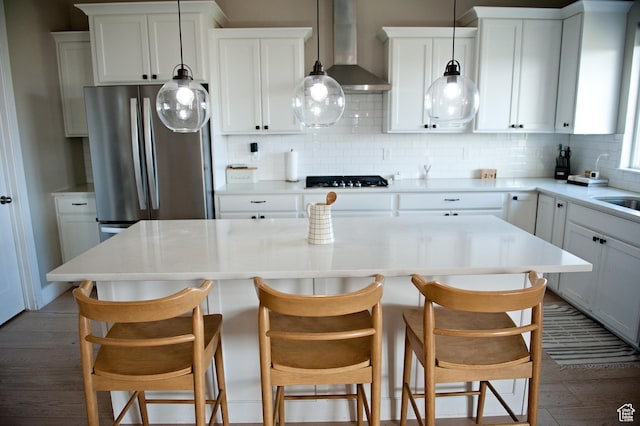 224 S Dry Creek Ln W, Vineyard, UT 84058 - kitchen with wall chimney exhaust hood, tasteful backsplash, a kitchen island, and light countertops
