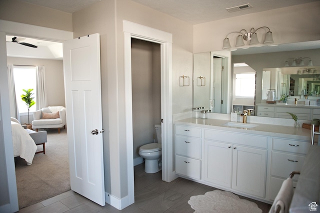 224 S Dry Creek Ln W, Vineyard, UT 84058 - bathroom with ensuite bath, toilet, vanity, and a ceiling fan
