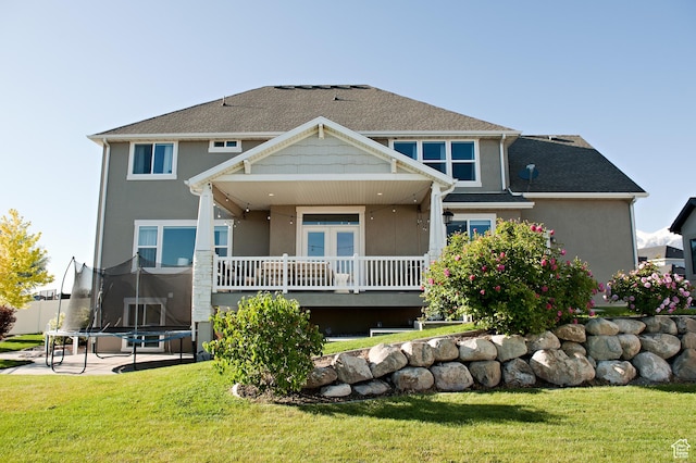 224 S Dry Creek Ln W, Vineyard, UT 84058 - rear view of house with a trampoline, a yard, and stucco siding