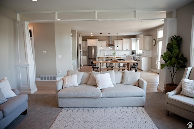 224 S Dry Creek Ln W, Vineyard, UT 84058 - living area featuring decorative columns, recessed lighting, and light wood-type flooring