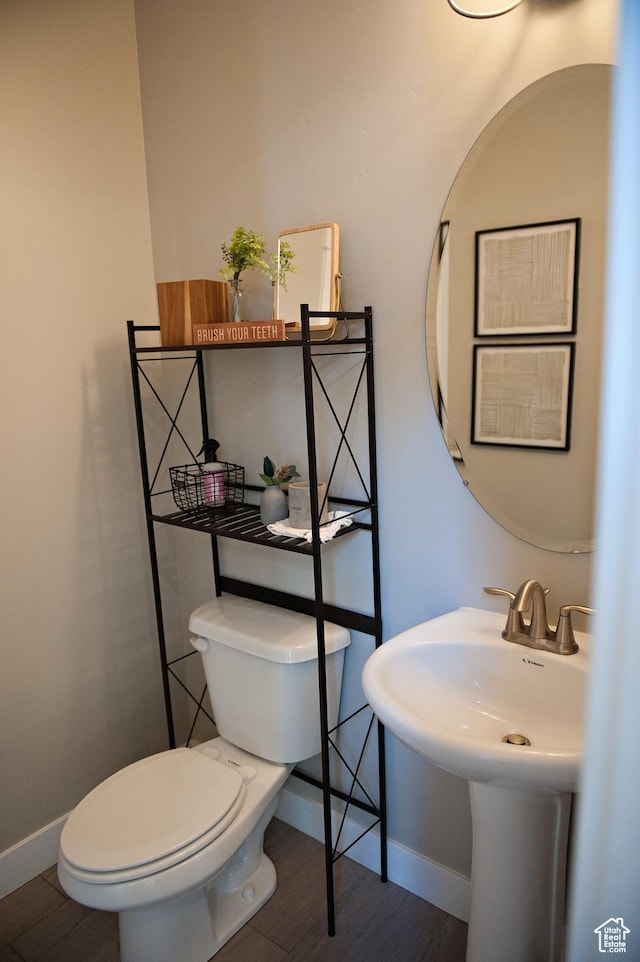 224 S Dry Creek Ln W, Vineyard, UT 84058 - bathroom featuring toilet, baseboards, and wood finished floors