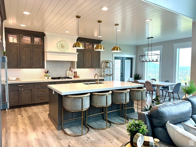 191 E 3475 N, North Ogden, UT 84414 - kitchen with a sink, light countertops, dark brown cabinetry, recessed lighting, and glass insert cabinets