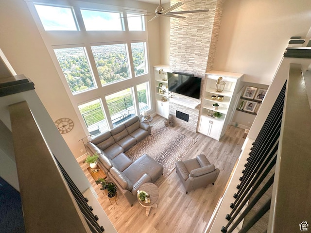 191 E 3475 N, North Ogden, UT 84414 - living area with a fireplace, a high ceiling, light wood-style floors, and a ceiling fan
