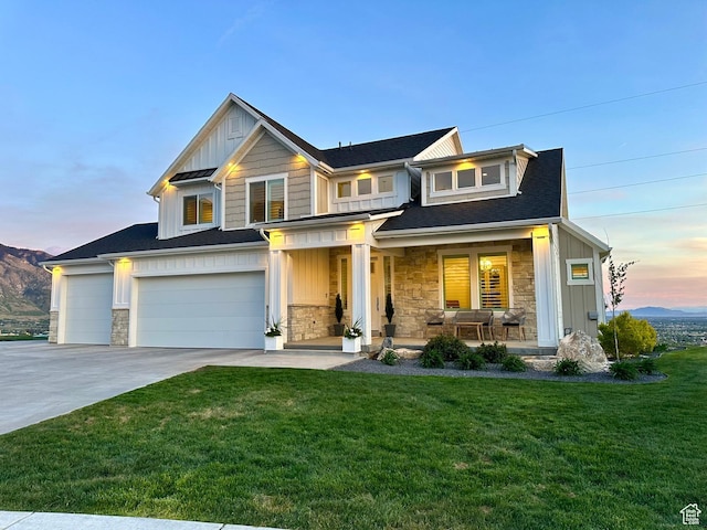 191 E 3475 N, North Ogden, UT 84414 - view of front of home featuring board and batten siding, a porch, stone siding, and driveway