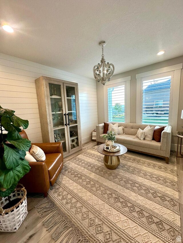 191 E 3475 N, North Ogden, UT 84414 - living area with wood finished floors, a chandelier, and a textured ceiling