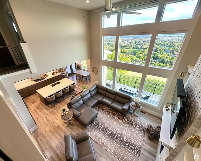 191 E 3475 N, North Ogden, UT 84414 - living area with a towering ceiling, wood finished floors, a ceiling fan, plenty of natural light, and recessed lighting