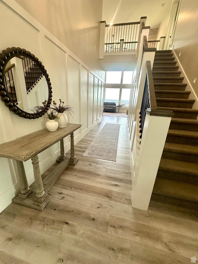 191 E 3475 N, North Ogden, UT 84414 - hall featuring stairway, a high ceiling, wood finished floors, and baseboards