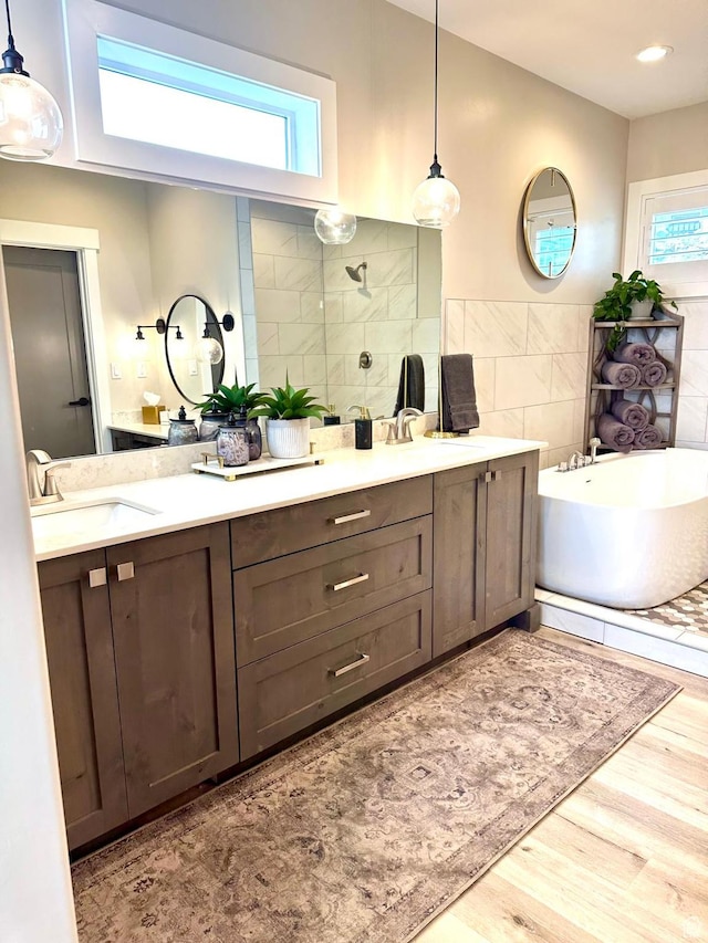 191 E 3475 N, North Ogden, UT 84414 - full bath with tile walls, a freestanding bath, a tile shower, wood finished floors, and double vanity