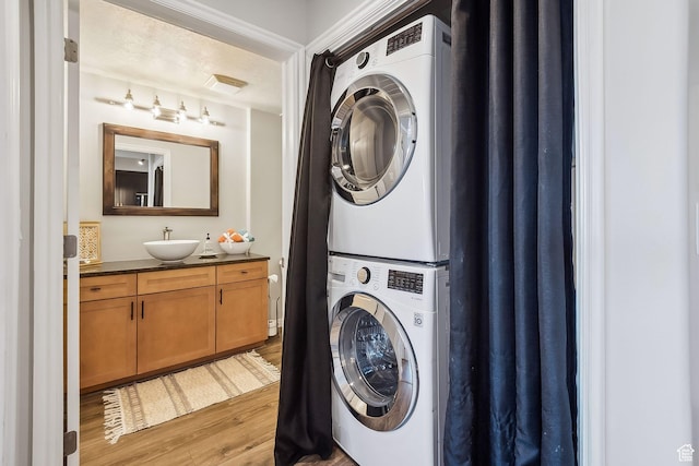 5 S 500 W Unit 506, Salt Lake City, UT 84101 - laundry room featuring stacked washer / drying machine, a sink, and light wood finished floors