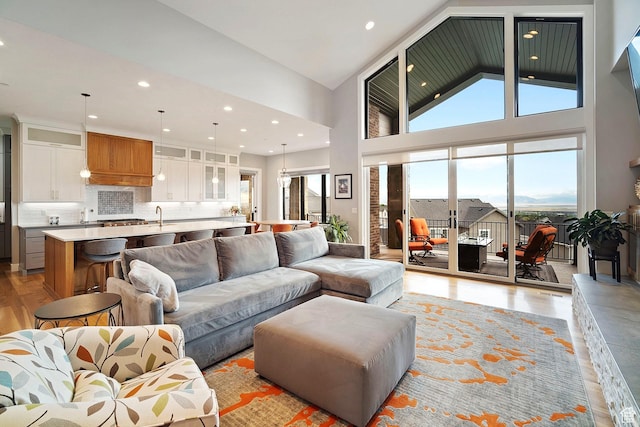 3196 E 25 S, Layton, UT 84040 - living area featuring light wood finished floors, high vaulted ceiling, and recessed lighting