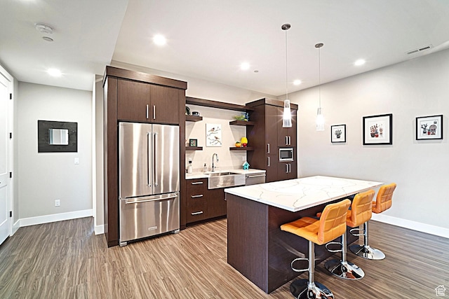 3196 E 25 S, Layton, UT 84040 - kitchen featuring appliances with stainless steel finishes, a sink, open shelves, wood finished floors, and recessed lighting