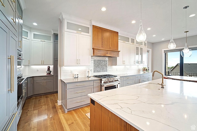 3196 E 25 S, Layton, UT 84040 - kitchen featuring a sink, appliances with stainless steel finishes, light wood finished floors, recessed lighting, and light stone counters