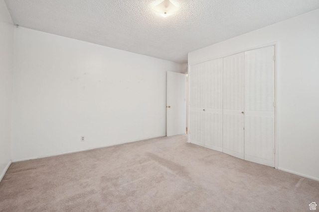 631 N 1200 W Unit A203, Salt Lake City, UT 84116 - unfurnished bedroom with carpet flooring, a closet, and a textured ceiling