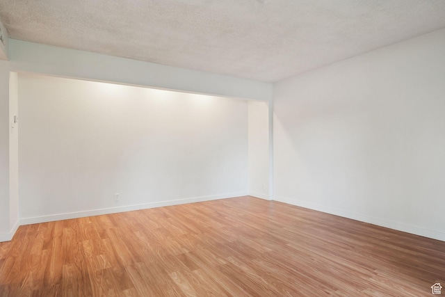 631 N 1200 W Unit A203, Salt Lake City, UT 84116 - unfurnished room with light wood-type flooring, baseboards, and a textured ceiling