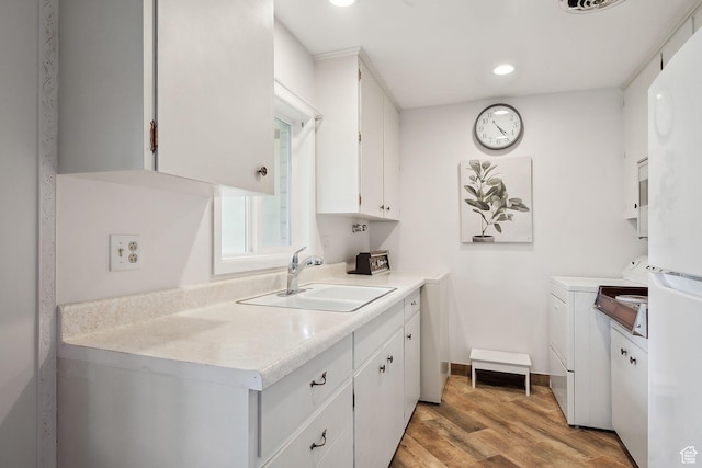 631 N 1200 W Unit A203, Salt Lake City, UT 84116 - laundry room featuring independent washer and dryer, cabinet space, light wood-style flooring, recessed lighting, and baseboards