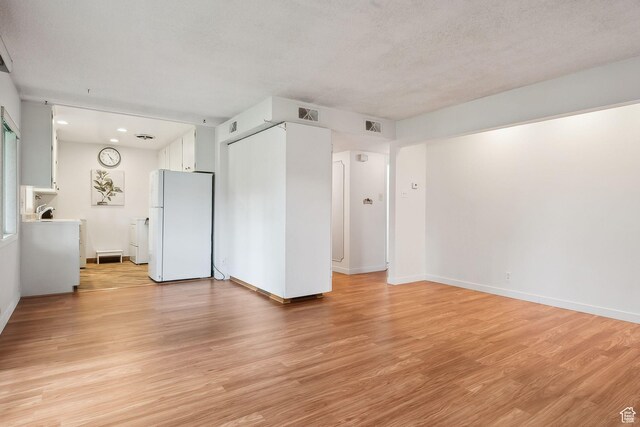 631 N 1200 W Unit A203, Salt Lake City, UT 84116 - spare room featuring light wood-style flooring, baseboards, washer / clothes dryer, and recessed lighting