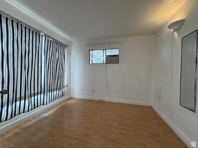 1666 W Warnock St S, Salt Lake City, UT 84119 - empty room with light wood-style flooring, baseboards, and cooling unit