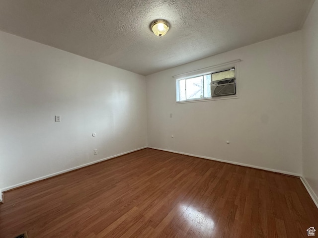 1666 W Warnock St S, Salt Lake City, UT 84119 - empty room with wood finished floors, baseboards, a textured ceiling, and cooling unit