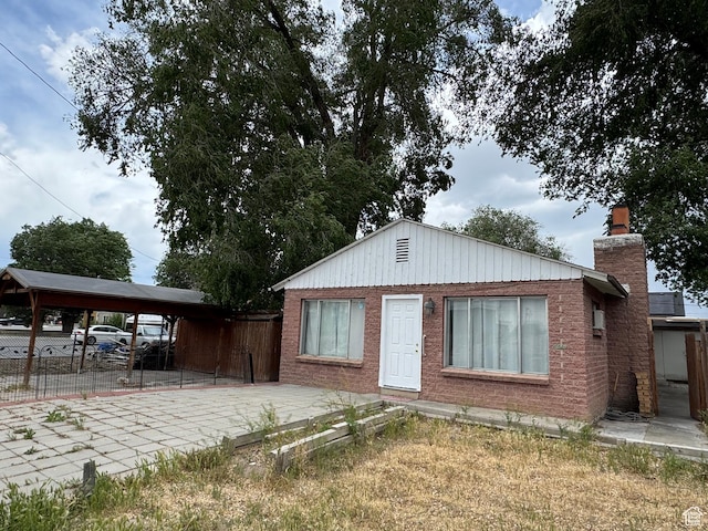 1666 W Warnock St S, Salt Lake City, UT 84119 - view of front of property featuring fence, a chimney, and brick siding