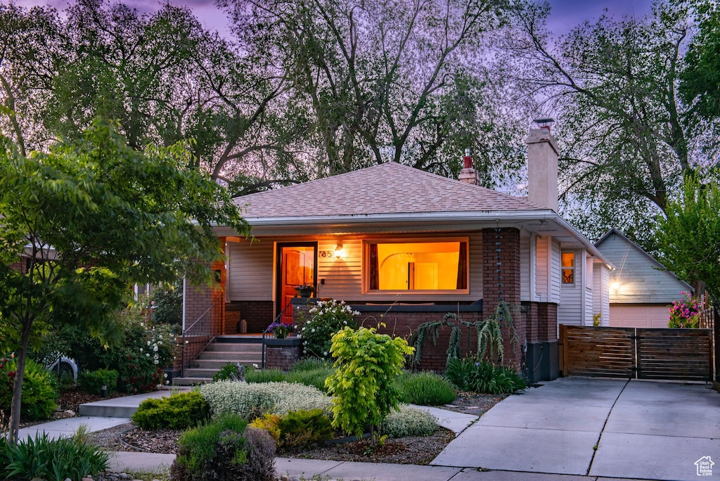 765 E Harrison Ave, Salt Lake City, UT 84105 - view of front of house featuring brick siding, a chimney, and covered porch