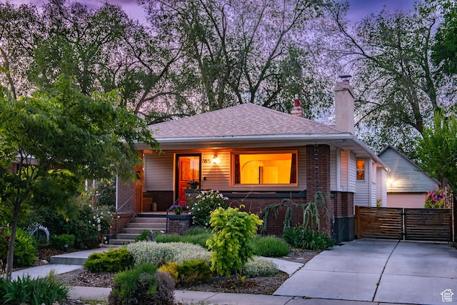 765 E Harrison Ave, Salt Lake City, UT 84105 - view of front of house featuring brick siding, a chimney, and covered porch