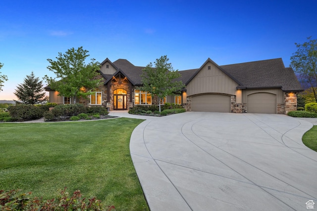 1515 E Maple St, Mapleton, UT 84664 - view of front of home featuring stone siding, driveway, a front lawn, and a garage