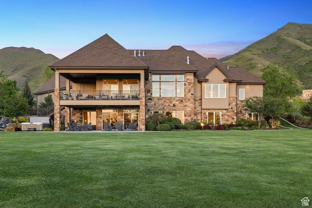 1515 E Maple St, Mapleton, UT 84664 - back of property featuring stone siding, a lawn, a mountain view, and roof with shingles