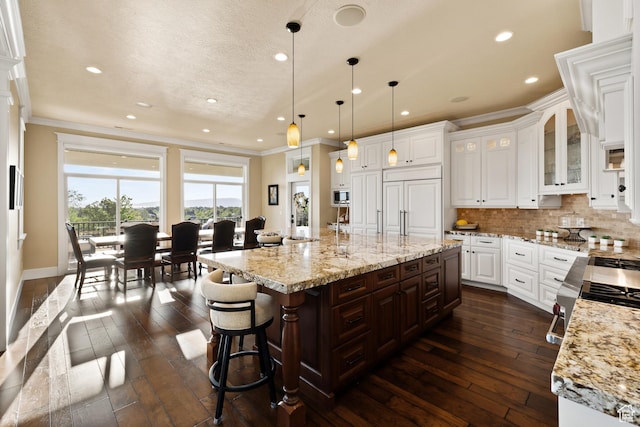 1515 E Maple St, Mapleton, UT 84664 - kitchen featuring ornamental molding, dark wood-style flooring, recessed lighting, tasteful backsplash, and white cabinetry